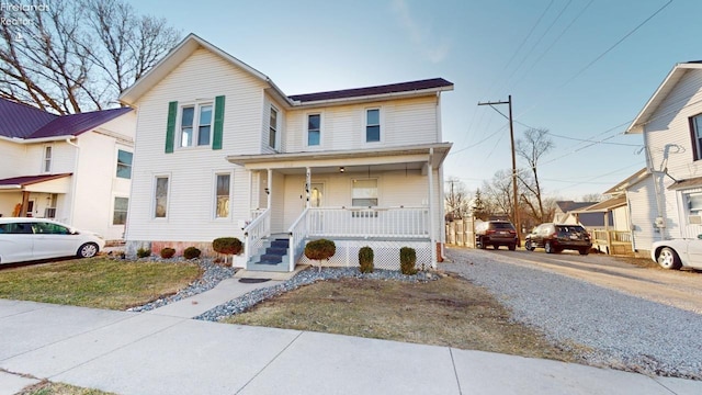 view of front of house with a porch and driveway