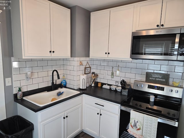 kitchen featuring a sink, white cabinets, and stainless steel appliances