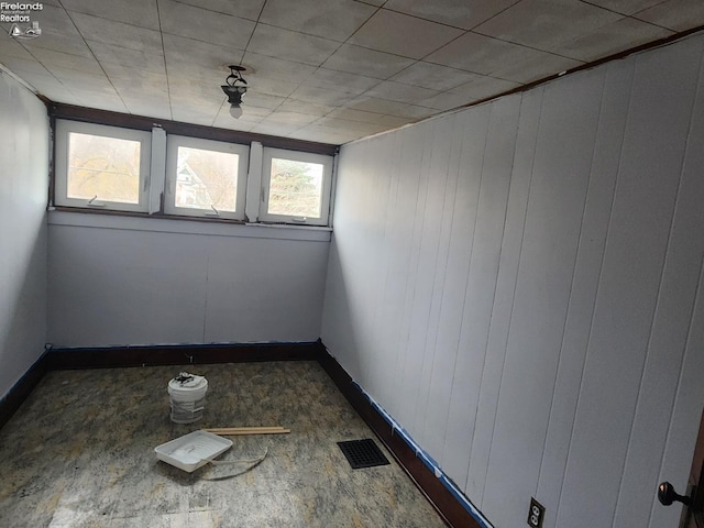 empty room with baseboards and visible vents