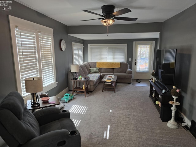 carpeted living room with a ceiling fan