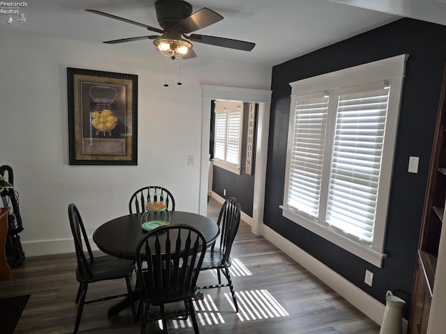 dining area featuring light wood-style floors, baseboards, and ceiling fan