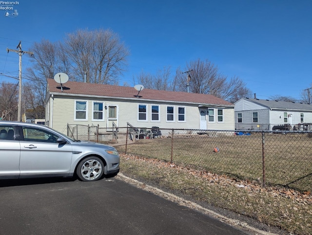 manufactured / mobile home with a front lawn and a fenced front yard