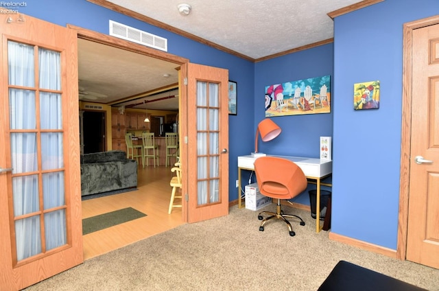 office with visible vents, crown molding, carpet floors, french doors, and a textured ceiling