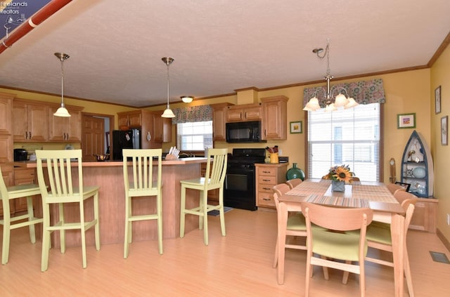 dining area featuring a chandelier, visible vents, light wood-style flooring, and crown molding