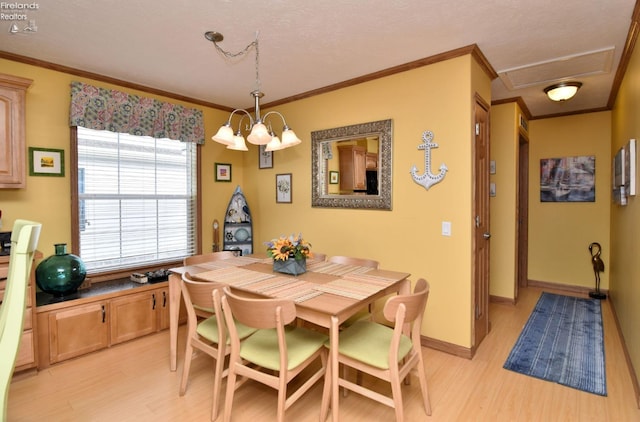 dining space with baseboards, an inviting chandelier, light wood-style flooring, and crown molding