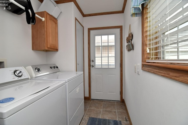 washroom with baseboards, washing machine and clothes dryer, cabinet space, tile patterned flooring, and crown molding