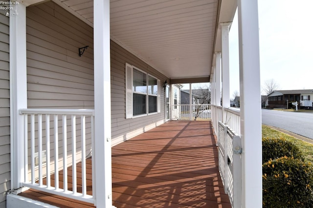 wooden terrace featuring covered porch