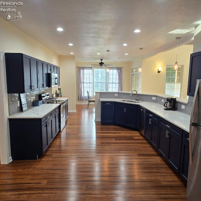 115 Beech St, Kelleys Island, OH 43438 - kitchen featuring ceiling fan, appliances with stainless steel finishes, a sink, tasteful backsplash, and dark wood-style floors