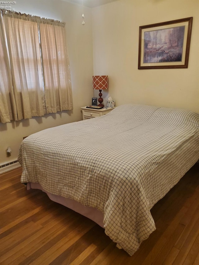 bedroom with hardwood / wood-style floors