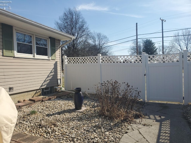 exterior space featuring a gate and fence