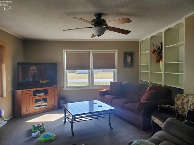 living area with a textured ceiling, carpet flooring, and ceiling fan