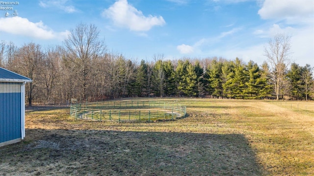 view of yard with a rural view and fence