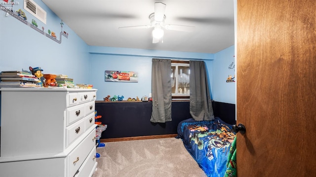 carpeted bedroom with a ceiling fan and visible vents