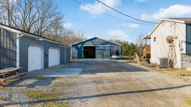 detached garage featuring central AC unit