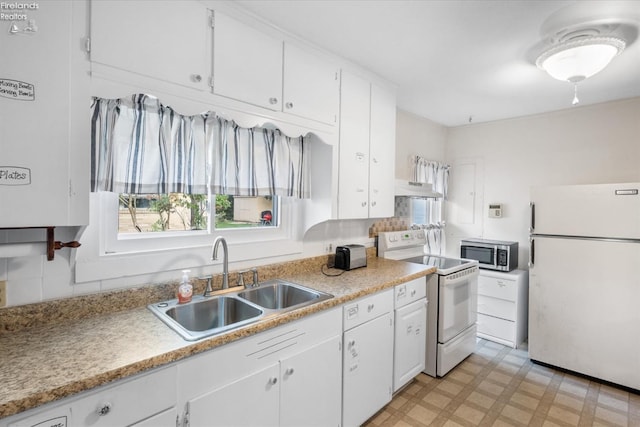 kitchen with white appliances, light floors, a sink, white cabinets, and under cabinet range hood