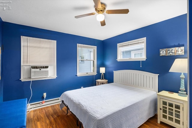 bedroom with ceiling fan, cooling unit, wood finished floors, and a baseboard radiator