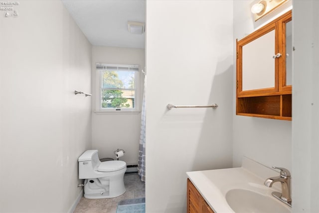 bathroom with baseboards, toilet, baseboard heating, and vanity