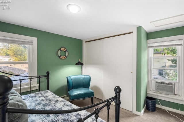 bedroom with a closet, carpet floors, baseboards, and cooling unit