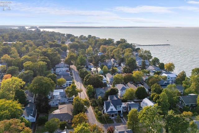 drone / aerial view featuring a residential view and a water view