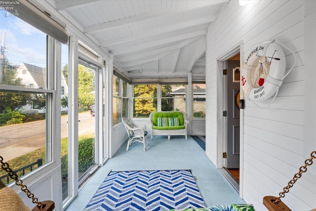 sunroom with vaulted ceiling with beams