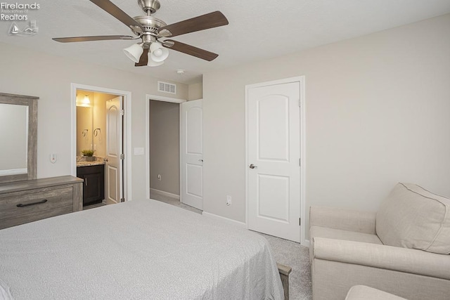 bedroom with visible vents, light carpet, ensuite bath, baseboards, and ceiling fan