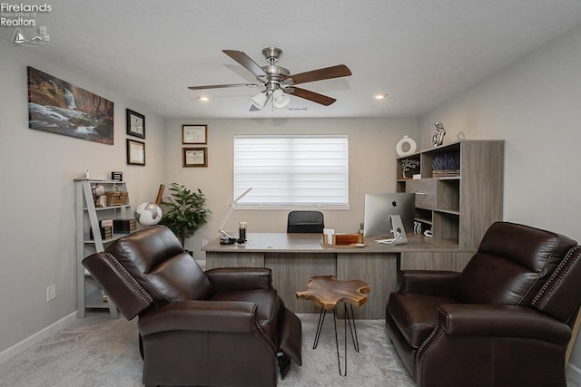 office area with light colored carpet, baseboards, and ceiling fan