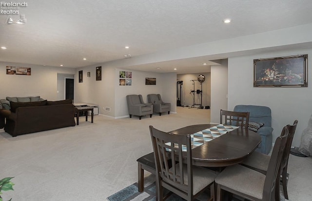 dining space with a textured ceiling, recessed lighting, baseboards, and light carpet