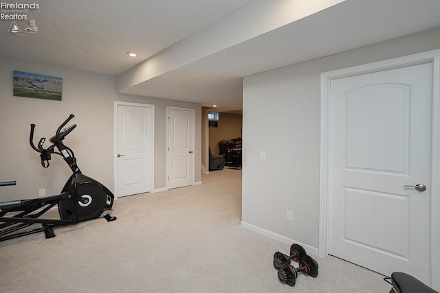 exercise area featuring recessed lighting, carpet, and baseboards