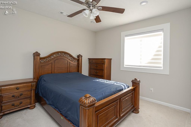 bedroom with visible vents, light colored carpet, a ceiling fan, and baseboards