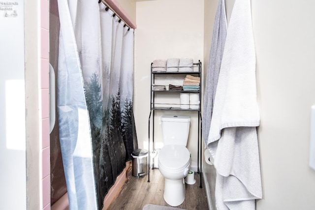 5041 State Route 99, Monroeville, OH 44847 - bathroom with a shower with shower curtain, toilet, and wood finished floors