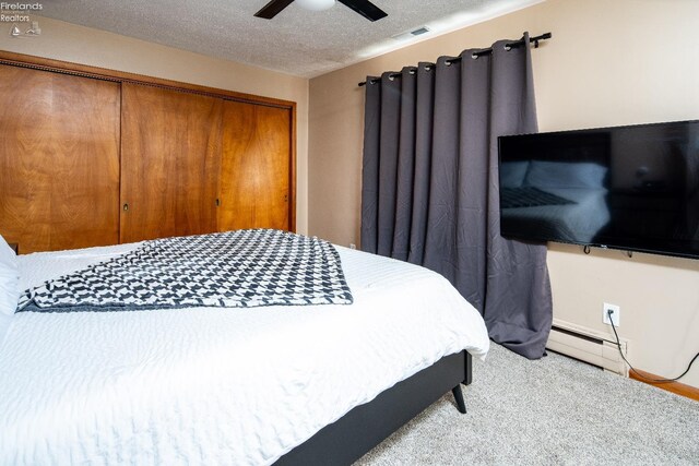 5041 State Route 99, Monroeville, OH 44847 - bedroom featuring visible vents, a textured ceiling, a closet, baseboard heating, and ceiling fan