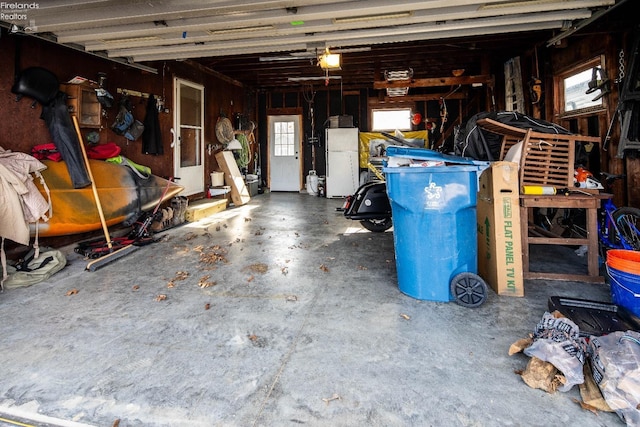 5041 State Route 99, Monroeville, OH 44847 - garage featuring a garage door opener and freestanding refrigerator