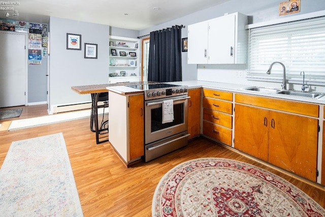 5041 State Route 99, Monroeville, OH 44847 - kitchen featuring high end stainless steel range, light countertops, baseboard heating, and a sink