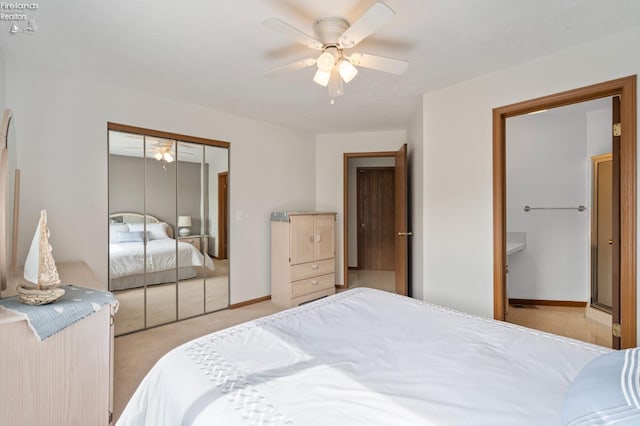 1789 N Windward Dr, Port Clinton, OH 43452 - bedroom with light carpet, a ceiling fan, ensuite bath, a closet, and baseboards