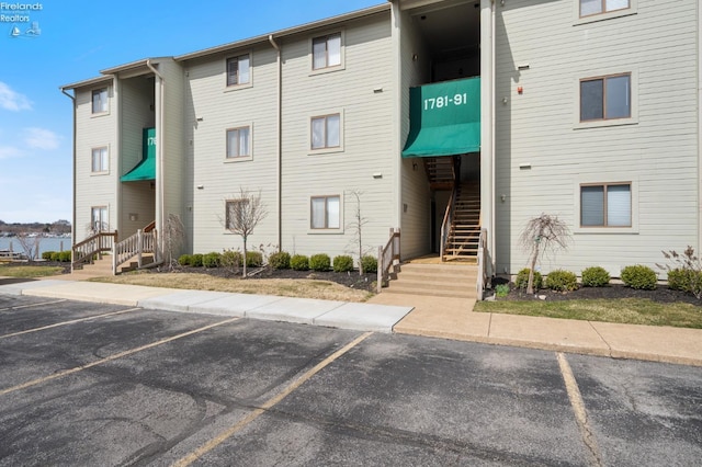 1789 N Windward Dr, Port Clinton, OH 43452 - view of building exterior featuring stairway and uncovered parking