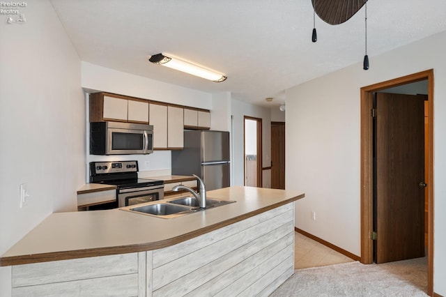 1789 N Windward Dr, Port Clinton, OH 43452 - kitchen with baseboards, light countertops, light carpet, stainless steel appliances, and a sink
