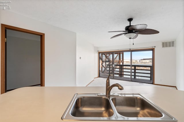 1789 N Windward Dr, Port Clinton, OH 43452 - kitchen with a ceiling fan, visible vents, a sink, light countertops, and a textured ceiling