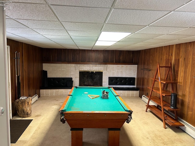 424 N Ridge Rd, Willard, OH 44890 - playroom featuring a fireplace with raised hearth, a drop ceiling, a baseboard heating unit, wood walls, and pool table