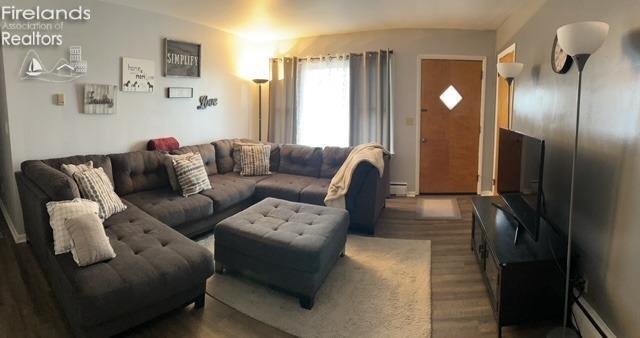 living room with wood finished floors and baseboard heating