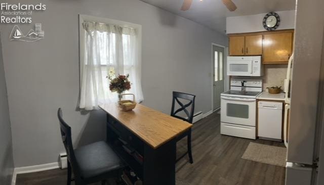 kitchen featuring a ceiling fan, dark wood finished floors, light countertops, and white appliances