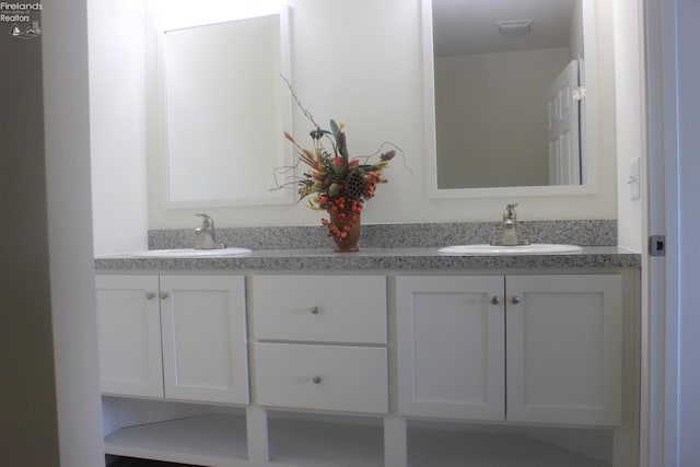 bathroom with double vanity and a sink