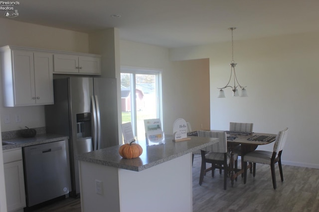 kitchen featuring dark wood-type flooring, pendant lighting, white cabinets, and dishwasher