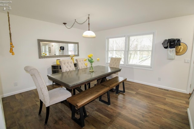 dining space featuring visible vents, baseboards, and dark wood finished floors