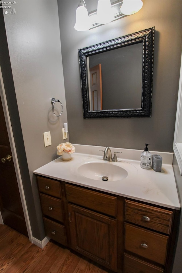 bathroom with vanity and wood finished floors
