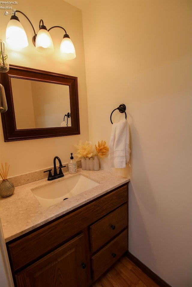 bathroom featuring vanity and wood finished floors