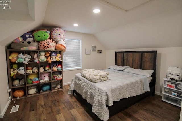 bedroom featuring wood finished floors, visible vents, baseboards, and lofted ceiling