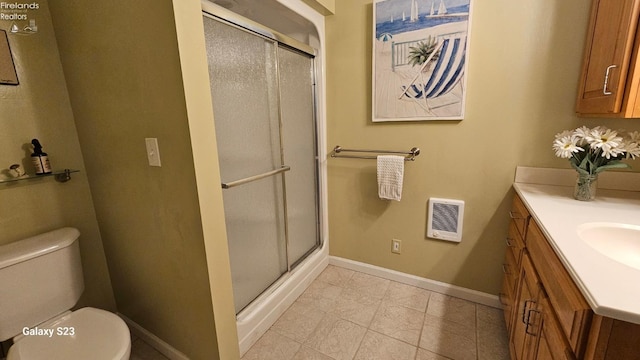 full bath featuring vanity, baseboards, visible vents, and a shower stall