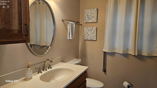 bathroom featuring toilet and vanity