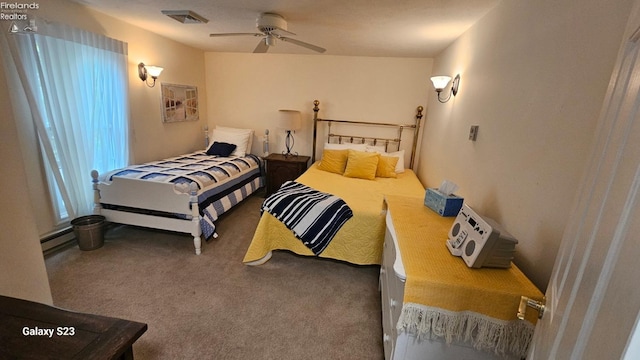 bedroom with a baseboard radiator, visible vents, ceiling fan, and carpet