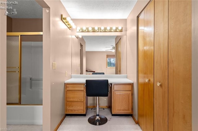 full bath with baseboards, ceiling fan, vanity, and a textured ceiling